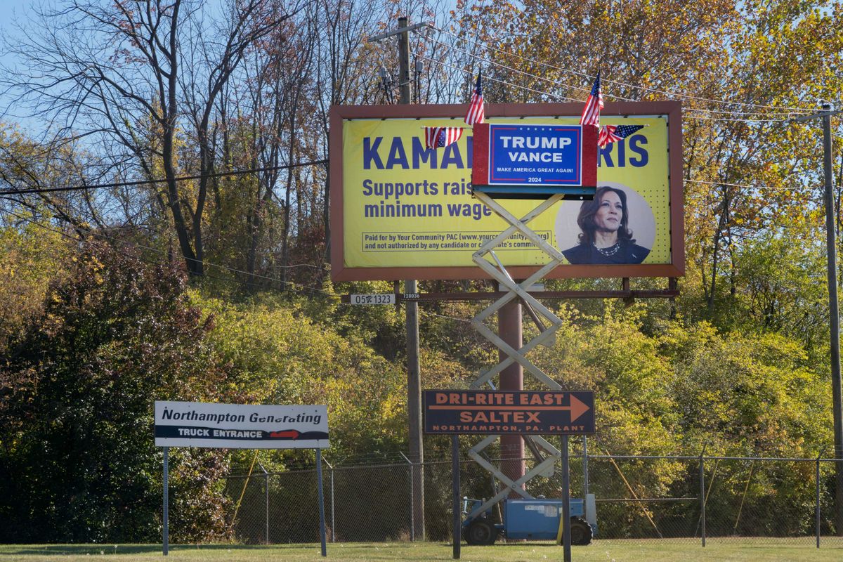 An improvised Trump-Vance display competes with a large Kamala Harris billboard in Northampton, Pennsylvania.