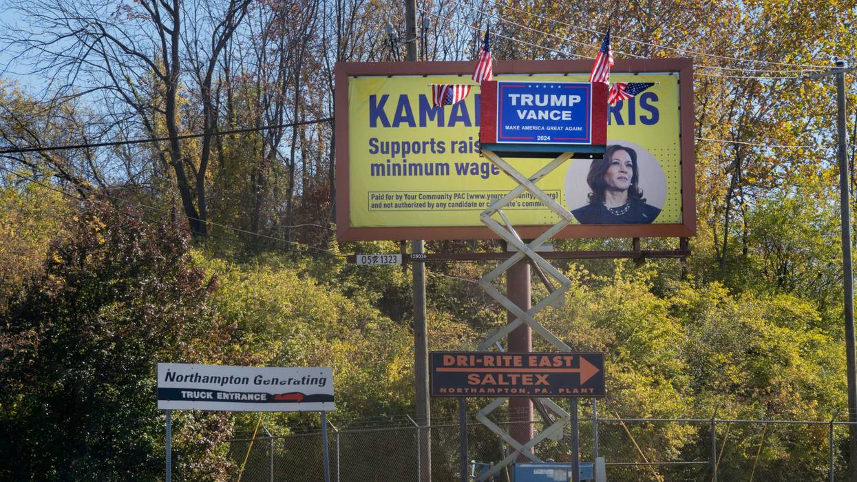 An improvised Trump-Vance display competes with a large Kamala Harris billboard in Northampton, Pennsylvania.