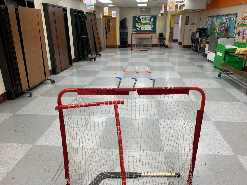 An indoor space at John Moffet Elementary in East Kensington is transformed into a makeshift street hockey rink.