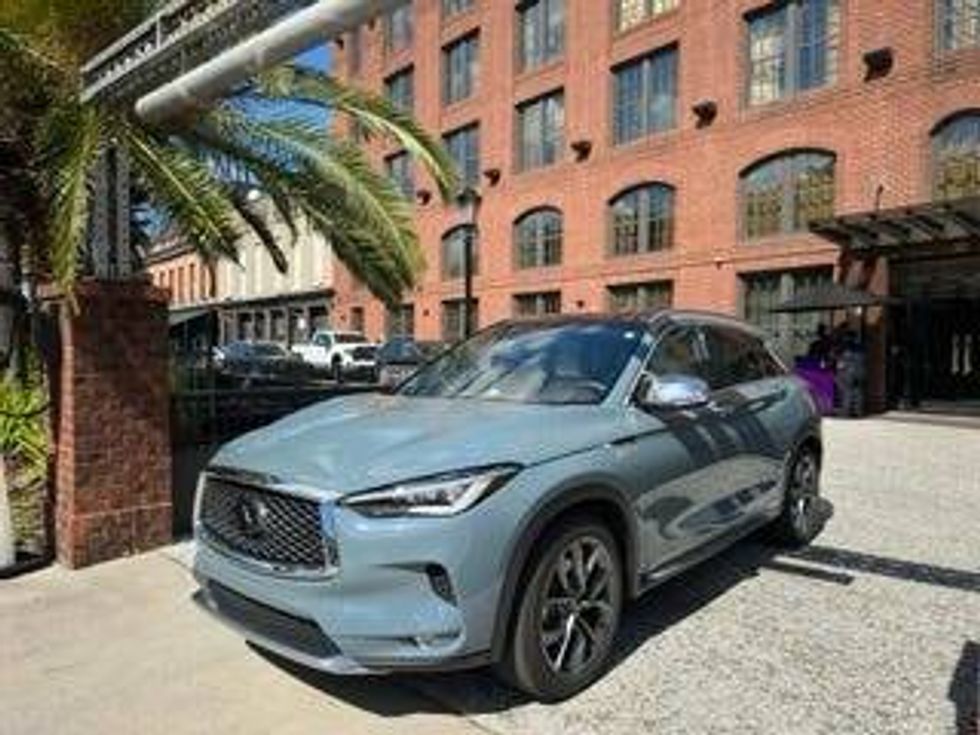 An Infiniti QX50 Hybrid, highlighting its elegant lines and innovative hybrid performance, captured in a dynamic angle.