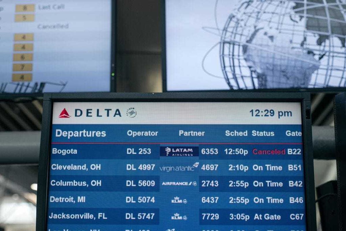 An information screen lists multiple cancelled flights at Terminal 4 of John F. Kennedy International Airport on December 24, 2021 in New York City. Thousands of travelers were left stranded across the country after multiple airlines cancelled Christmas Eve flights Friday due to rising Omicron variant cases of COVID-19, staffing shortages and severe weather. (Photo by Scott Heins/Getty Images)