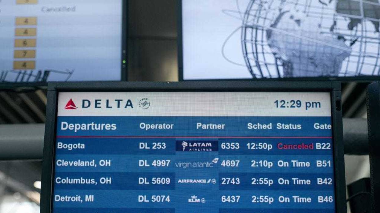 An information screen lists multiple cancelled flights at Terminal 4 of John F. Kennedy International Airport on December 24, 2021 in New York City. Thousands of travelers were left stranded across the country after multiple airlines cancelled Christmas Eve flights Friday due to rising Omicron variant cases of COVID-19, staffing shortages and severe weather. (Photo by Scott Heins/Getty Images)