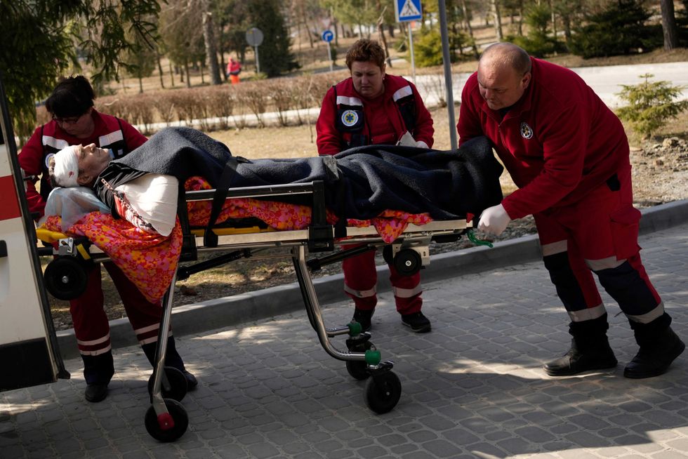 An injured man is wheeled on a stretcher at a local hospital in Novoiavorisk, western Ukraine