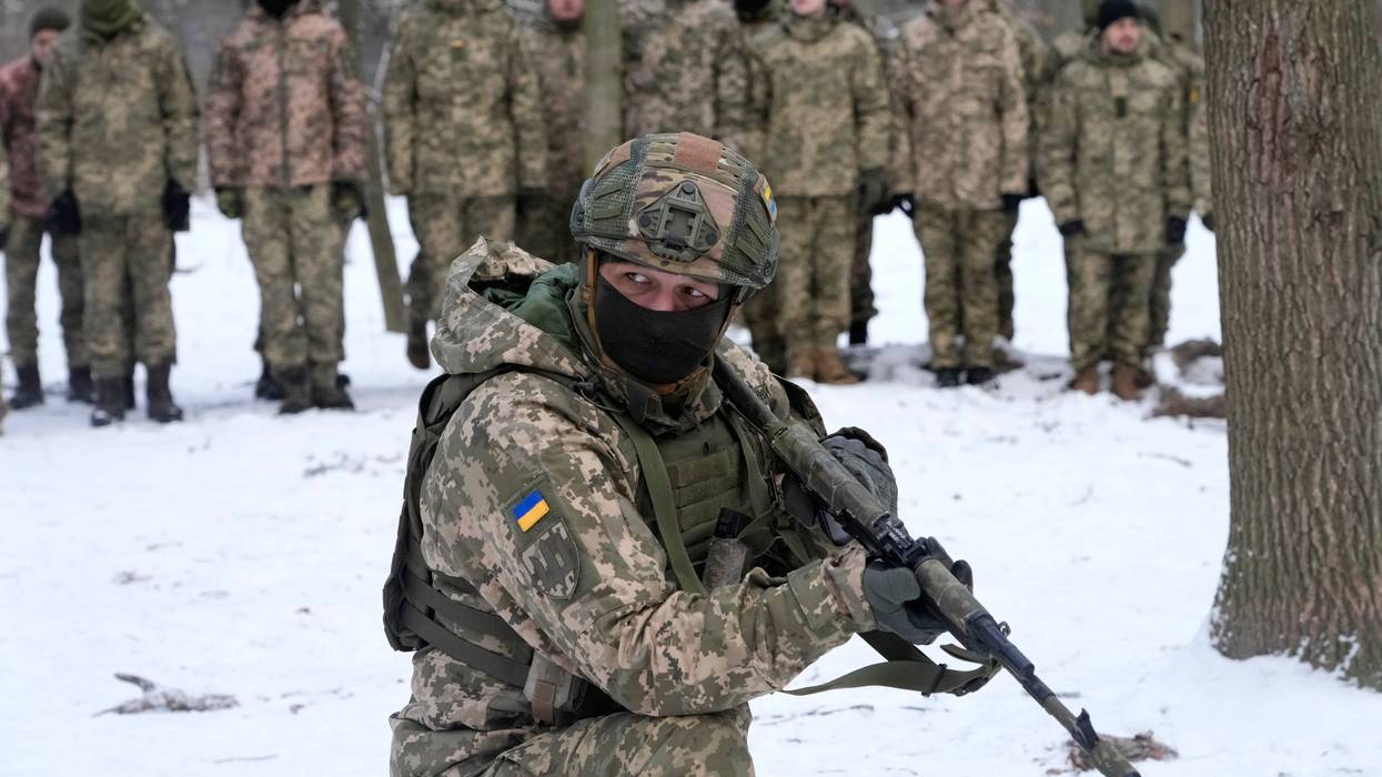 An instructor trains members of Ukraine's Territorial Defense Forces, volunteer military units of the Armed Forces, in a city park in Kyiv, Ukraine, Saturday, Jan. 22, 2022.