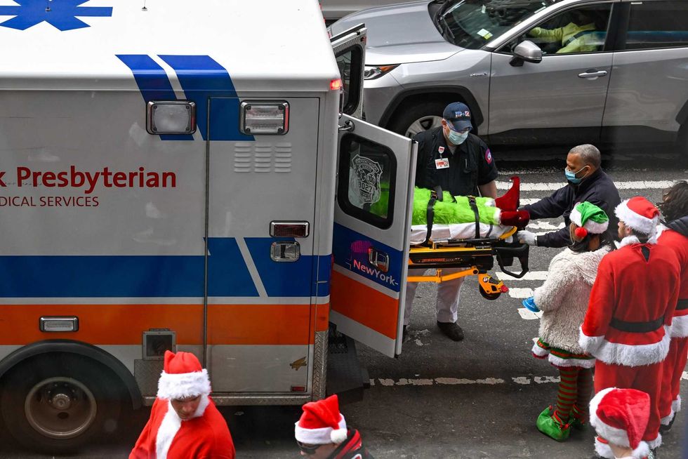An intoxicated person is taken by paramedics during SantaCon