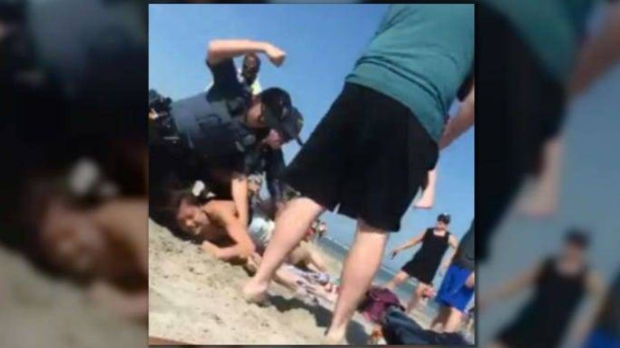 An investigation is underway after video shows a New Jersey police officer striking a woman several times during a beach arrest.