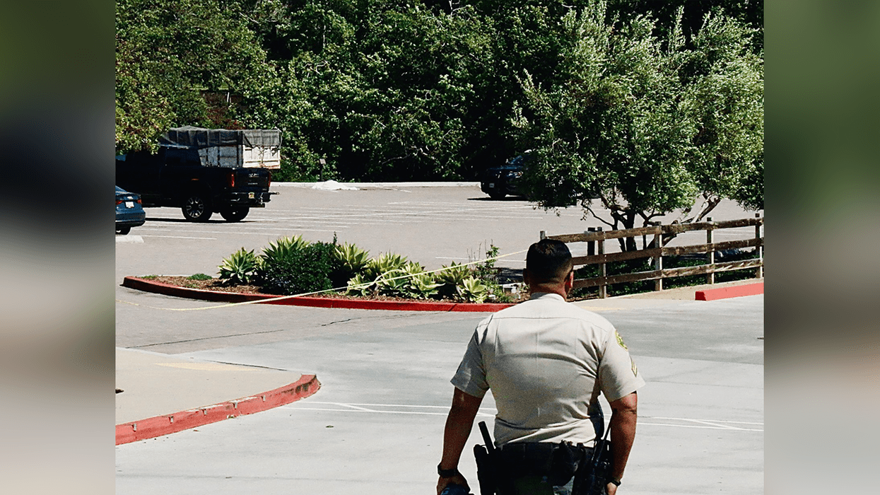An L.A. Sheriff's deputy on March 29, 2022 at the scene in Malibu, Calif. where a 58-year-old man was found dead in the parking lot of the Trancas Market shopping complex. The man was deemed to be an overnight security guard for the area.