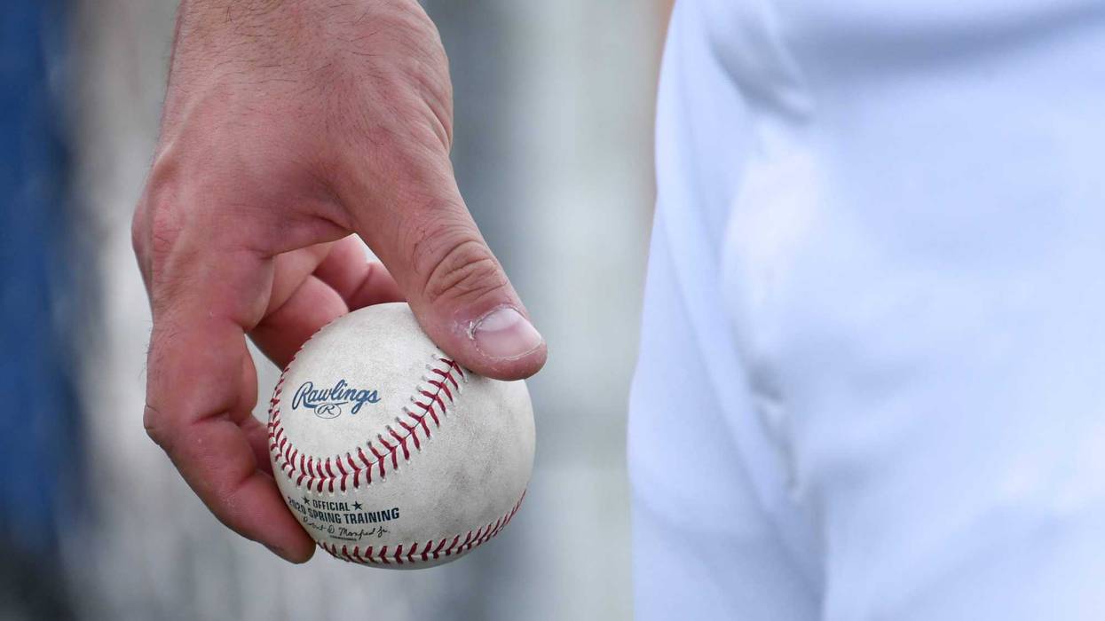 An MLB player holding a baseball.