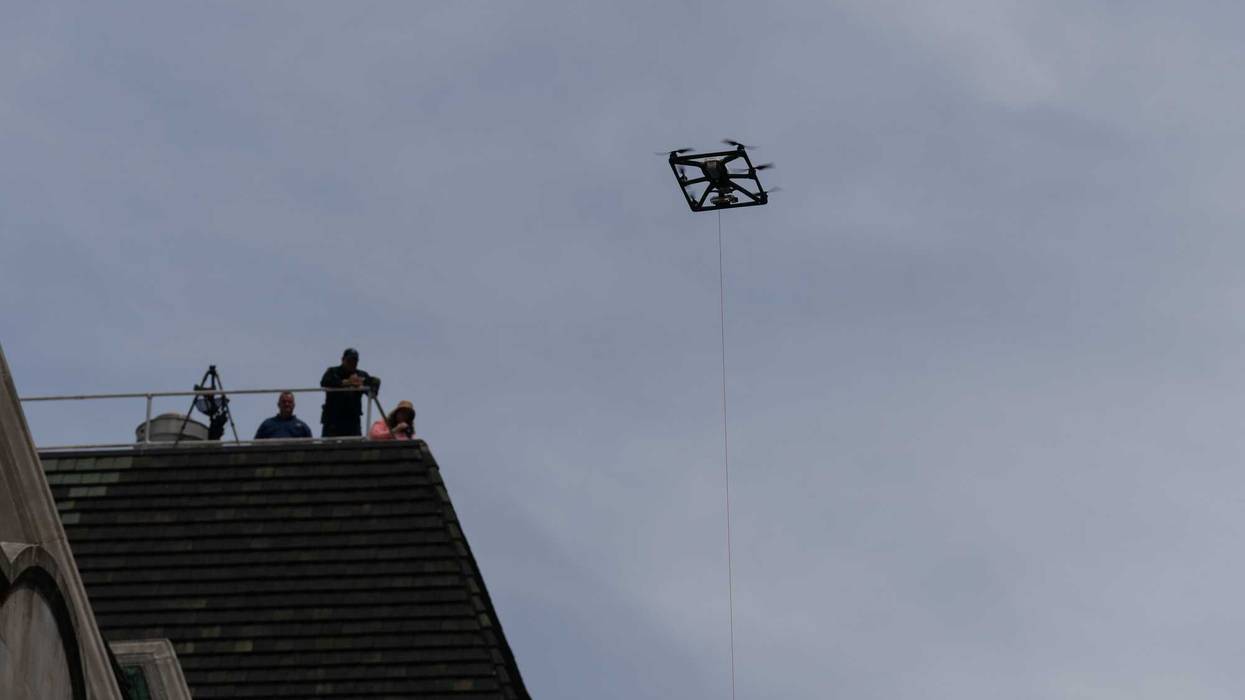 An NYPD drone and spotters on a roof are seen at the Israel Day on Fifth parade on June 2, 2024 in New York City.