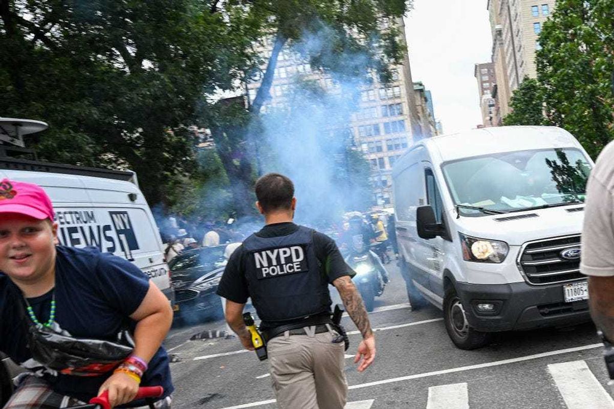 An NYPD officer responds to an unknown explosive device goes off as thousands of people gathered for a "giveaway" event announced by popular Twitch live streamer Kai Cenat in Union Square and the surrounding area on August 4, 2023 in New York City.