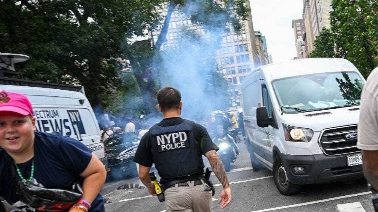 An NYPD officer responds to an unknown explosive device goes off as thousands of people gathered for a "giveaway" event announced by popular Twitch live streamer Kai Cenat in Union Square and the surrounding area on August 4, 2023 in New York City.