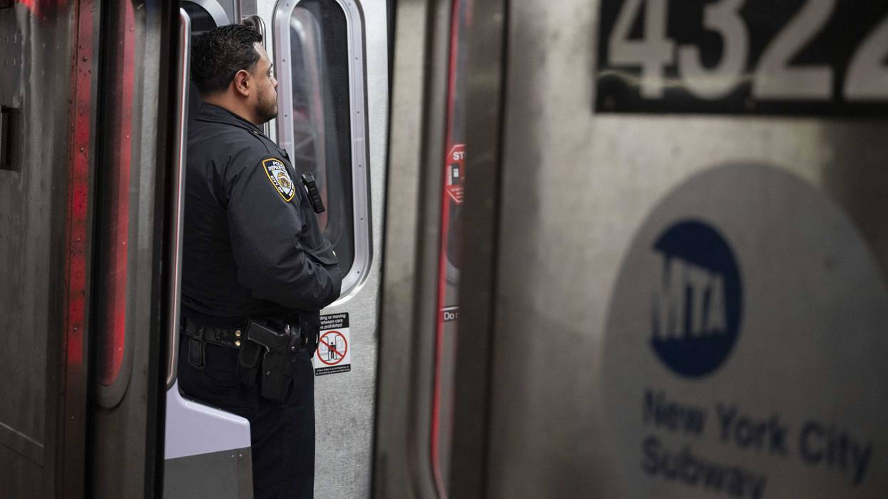 An NYPD officers stands aboard a subway train this month