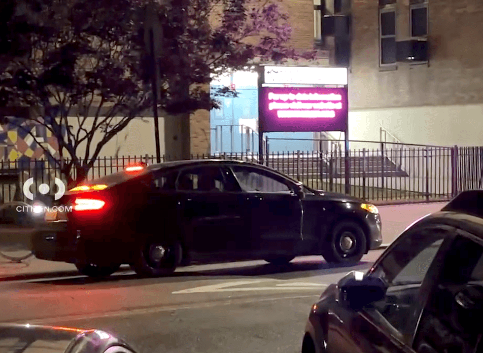 An NYPD vehicle is seen outside the park and near a school on Thursday night