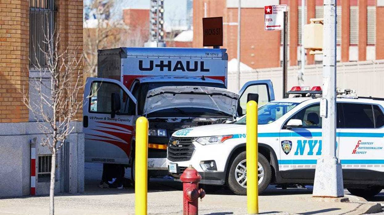 An NYPD vehicle is seen parked in front of a crashed U-Haul truck on Hamilton Avenue on February 13, 2023 in the Red Hook neighborhood of the Brooklyn borough in New York City.