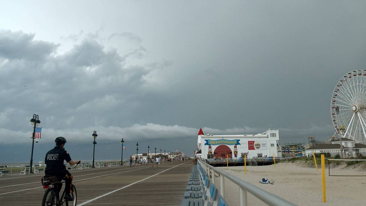 An Ocean City police officer patrols on a bike on the boardwalk, July 25, 2023.