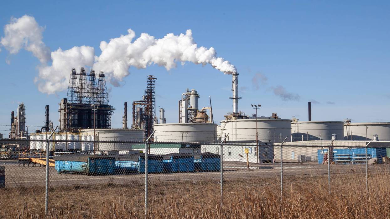 An oil refinery facility skyline. An oil refinery is a facility that takes crude oil and distills it into various useful petroleum products.