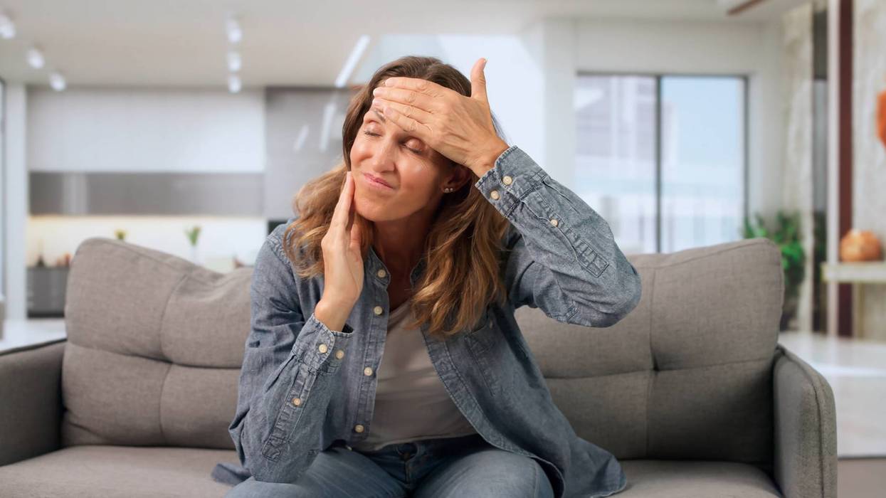 An Older Woman Sits In Her Room, Feeling Dizzy