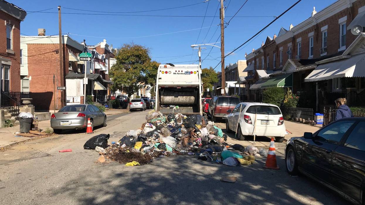 An oxygen tank caused an explosion when it was crushed in the back of this sanitation truck, injuring one worker.