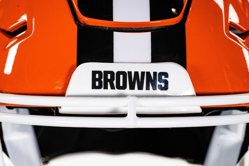 An up close view of the Browns new helmet featuring a glossy orange finis and white facemask
