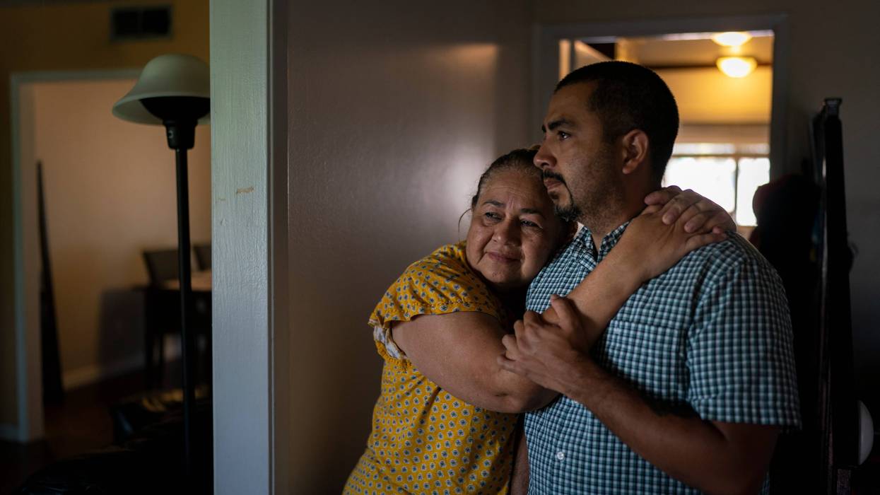 Ana Sandoval, mother of Eyvin Hernandez, a Los Angeles attorney who has been detained for five months in Venezuela, hugs her son Henry Martinez, Hernandez's half-brother, while posing for photos in Compton, Calif., Monday, Aug. 29, 2022. The Los Angeles attorney detained for five months in Venezuela is pleading for help from the Biden administration, saying in a secretly recorded jailhouse message that he feels forgotten by the U.S. government as he faces criminal charges at the hands of one of the nation's top adversaries.