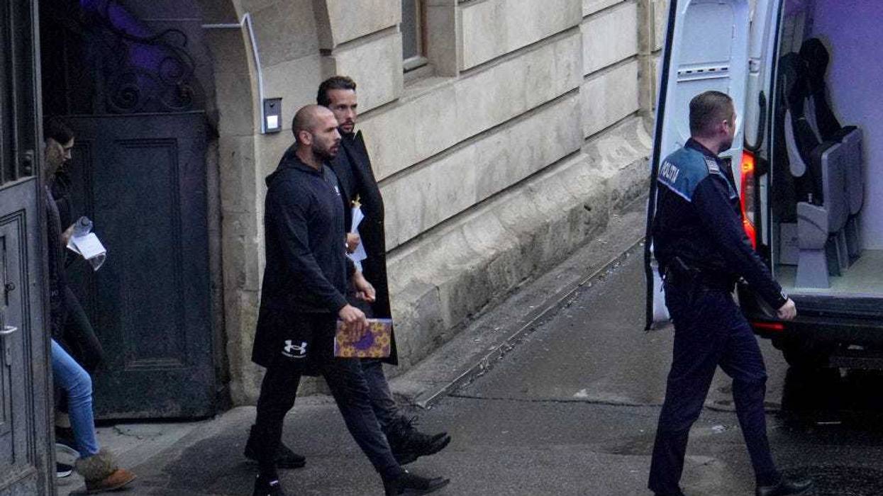 Andrew Tate (L) and Tristan Tate leave the Bucharest Court of Appeal after the hearing on their appeal to the decision of arrest for 30 days, on January 10, 2023 in Bucharest, Romania.
