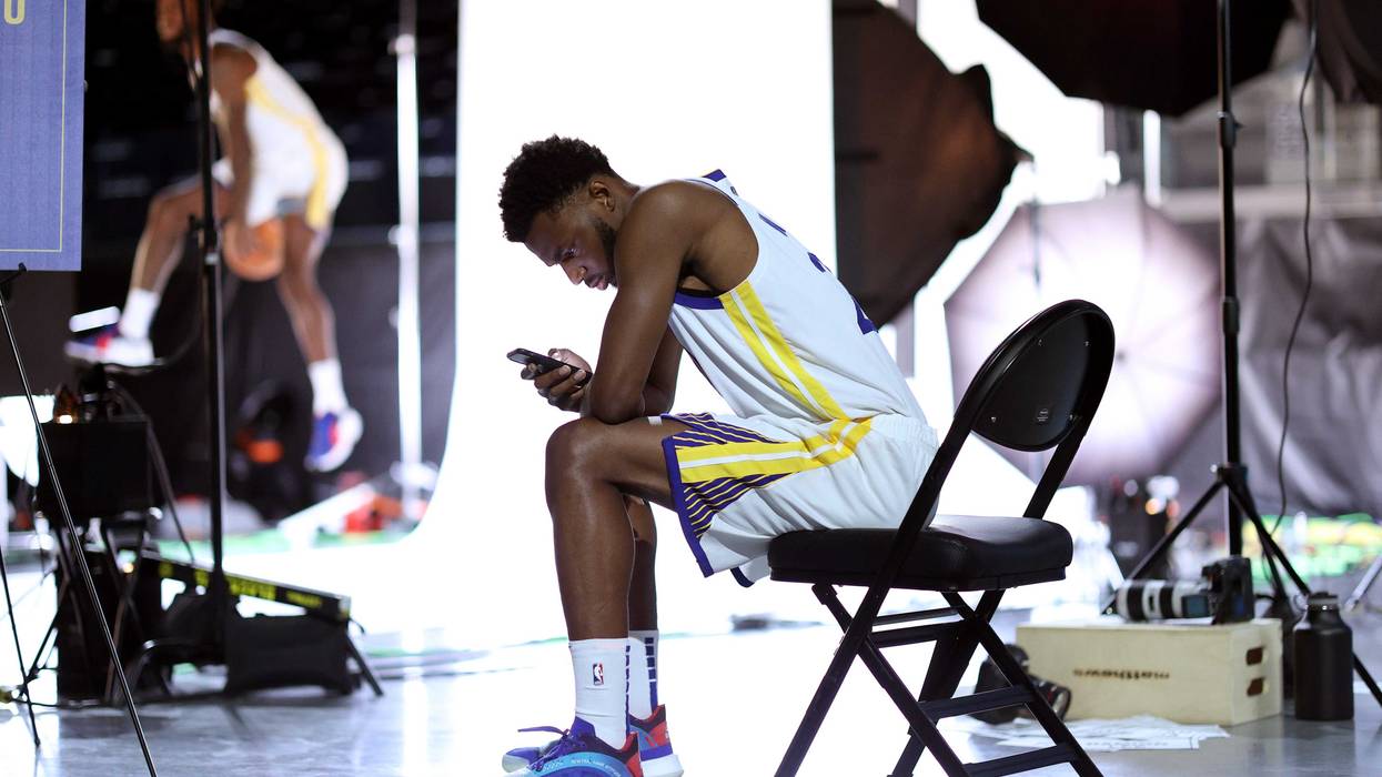 Andrew Wiggins #22 of the Golden State Warriors checks his phone during the Golden State Warriors Media Day at Chase Center on September 27, 2021 in San Francisco, California.