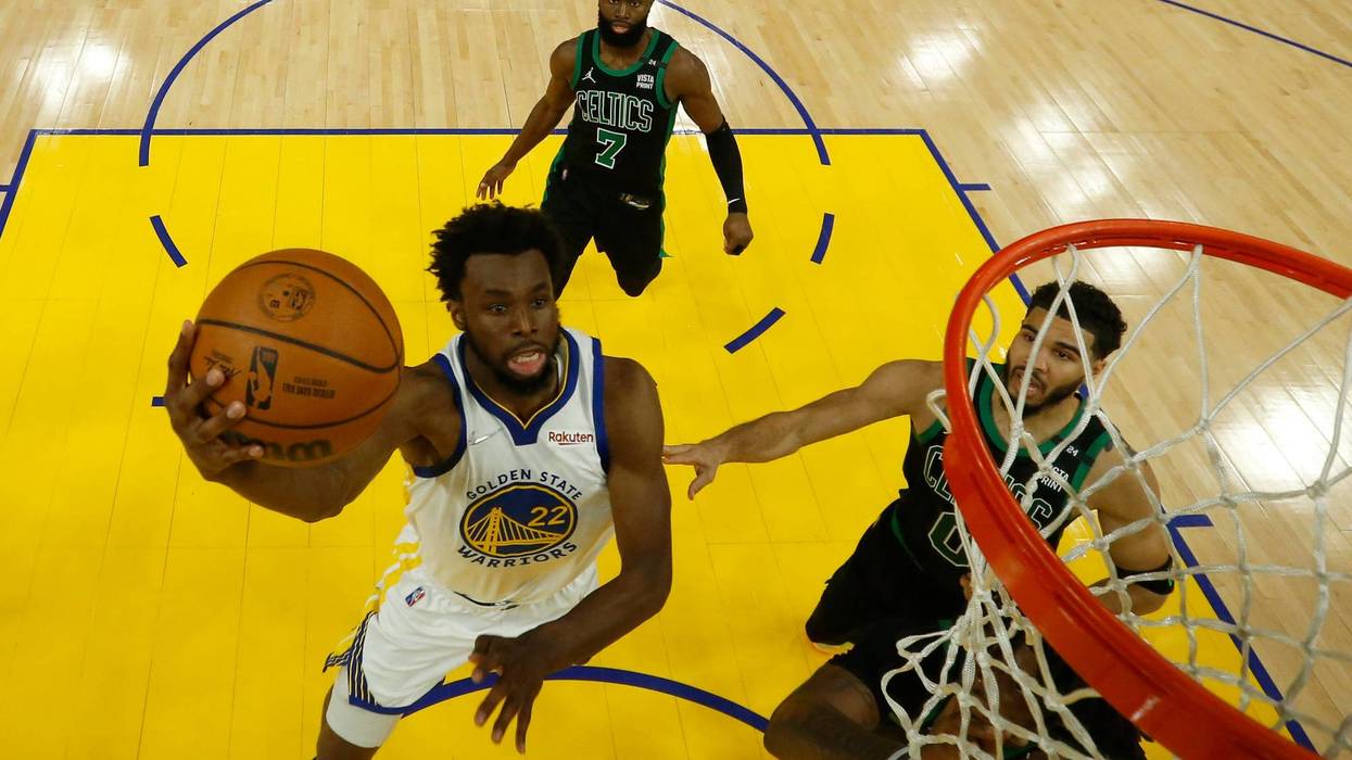 Andrew Wiggins #22 of the Golden State Warriors drives to the basket against Jaylen Brown #7 and Jayson Tatum #0 of the Boston Celtics during the first half in Game Five of the 2022 NBA Finals at Chase Center on June 13, 2022 in San Francisco, California.
