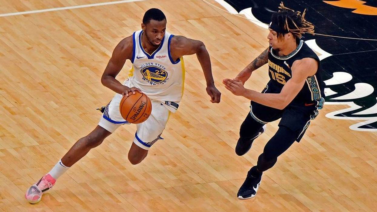 Andrew Wiggins #22 of the Golden State Warriors handles the ball against Brandon Clarke #15 of the Memphis Grizzlies during the second half at FedExForum on March 19, 2021 in Memphis, Tennessee.