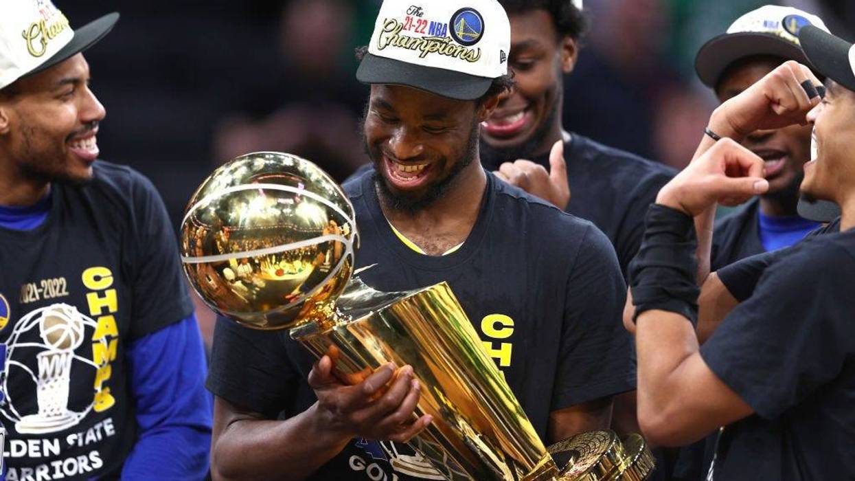 Andrew Wiggins of the Golden State Warriors celebrates with the Larry O'Brien Championship Trophy after defeating the Boston Celtics 103-90 in Game Six of the 2022 NBA Finals at TD Garden on June 16, 2022 in Boston, Massachusetts.