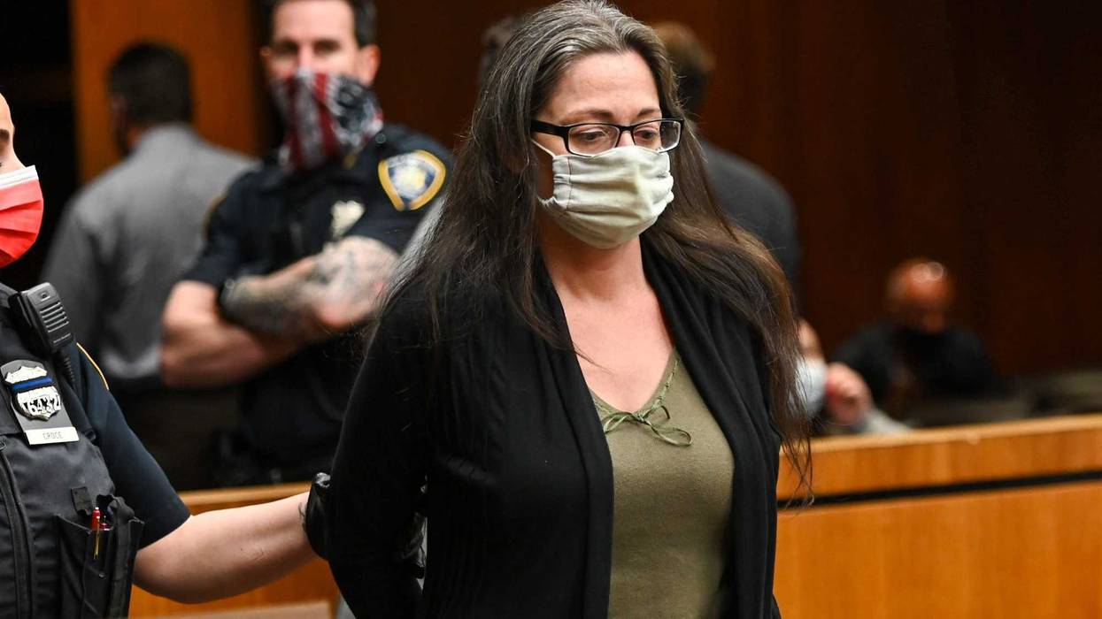 Angela Pollina who is charged with second-degree murder in the death of eight-year-old Thomas Valva, stands handcuffed inside Suffolk County Court in Riverhead, New York on May 13, 2021.