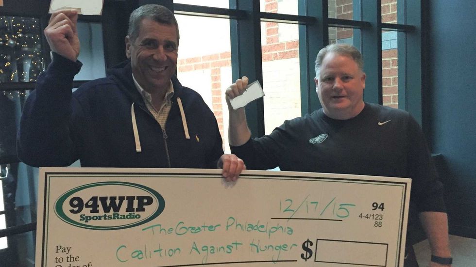 Angelo Cataldi in 2015 with then-Eagles coach Chip Kelly as they make a donation to the Greater Philadelphia Coalition Against Hunger.