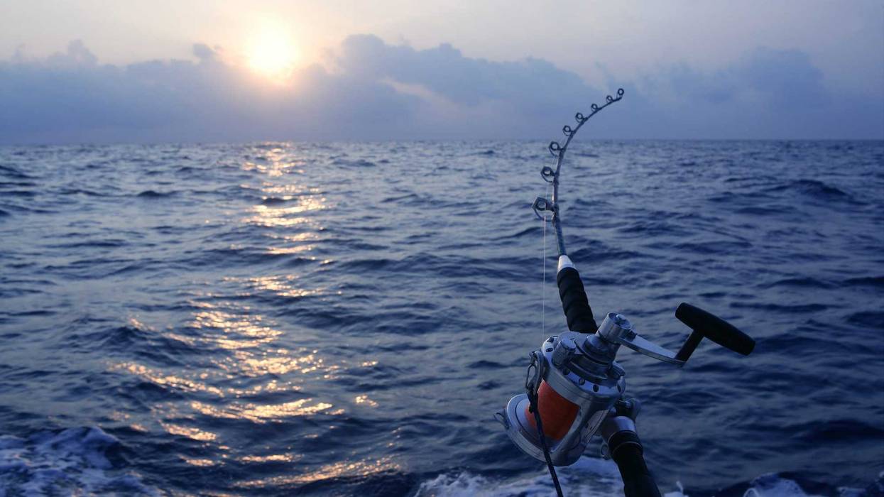 Angler boat big game fishing in saltwater ocean.