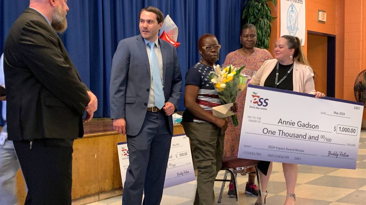 Annie Gadson (holding flowers) is honored as the region’s top sub during a ceremony Tuesday at Robeson High School.