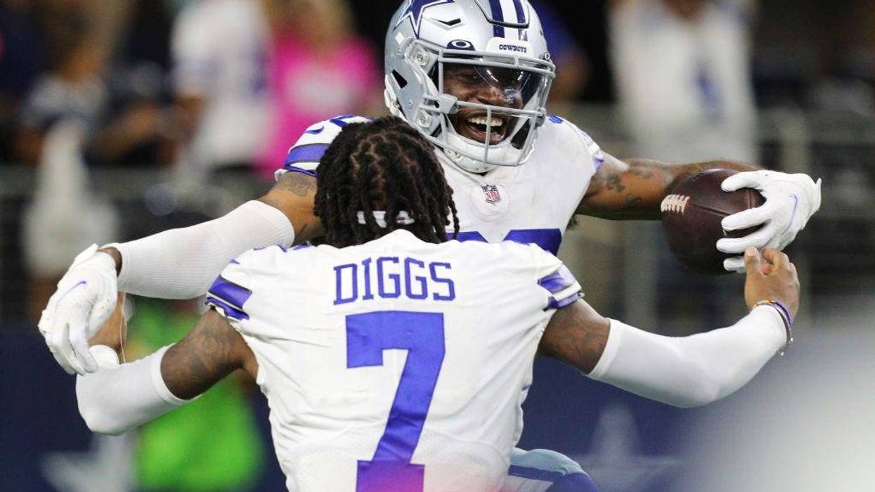 Anthony Brown #30 of the Dallas Cowboys celebrates a touchdown return with Trevon Diggs #7 after a turnover by the New York Giants during the fourth quarter at AT&T Stadium on October 10, 2021 in Arlington, Texas.