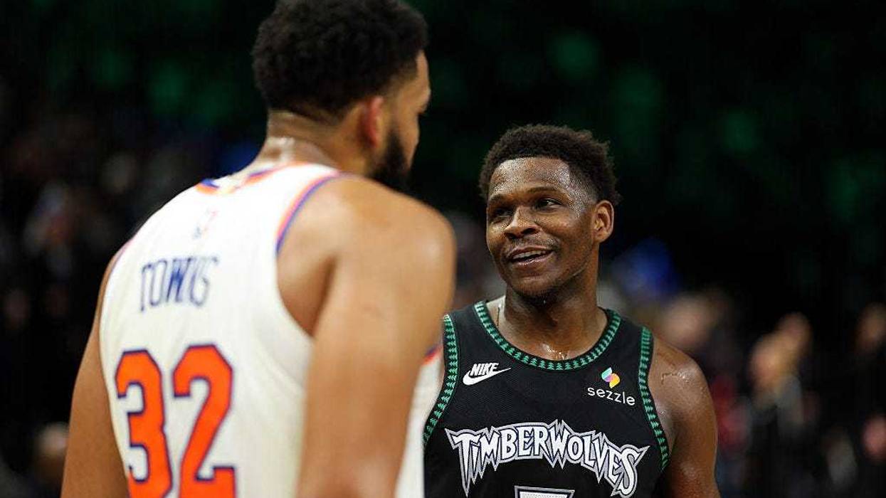 Anthony Edwards #5 of the Minnesota Timberwolves and Karl-Anthony Towns #32 of the New York Knicks interact after the game at Target Center on December 23, 2025 in Minneapolis, Minnesota. The Timberwolves defeated the Knicks 115-104.