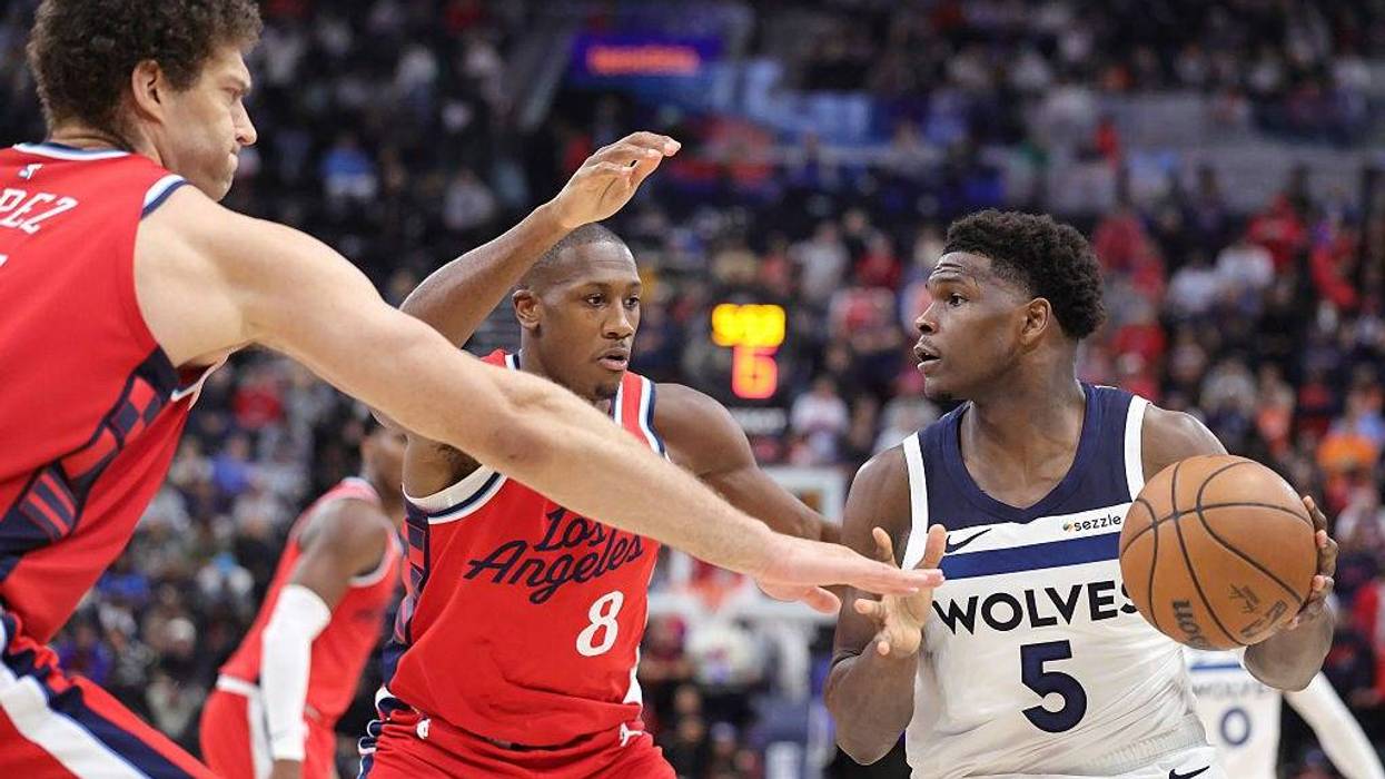 Anthony Edwards #5 of the Minnesota Timberwolves controls the ball against Kris Dunn #8 and Brook Lopez #11 of the LA Clippers in the first half at Intuit Dome on February 26, 2026 in Inglewood, California.