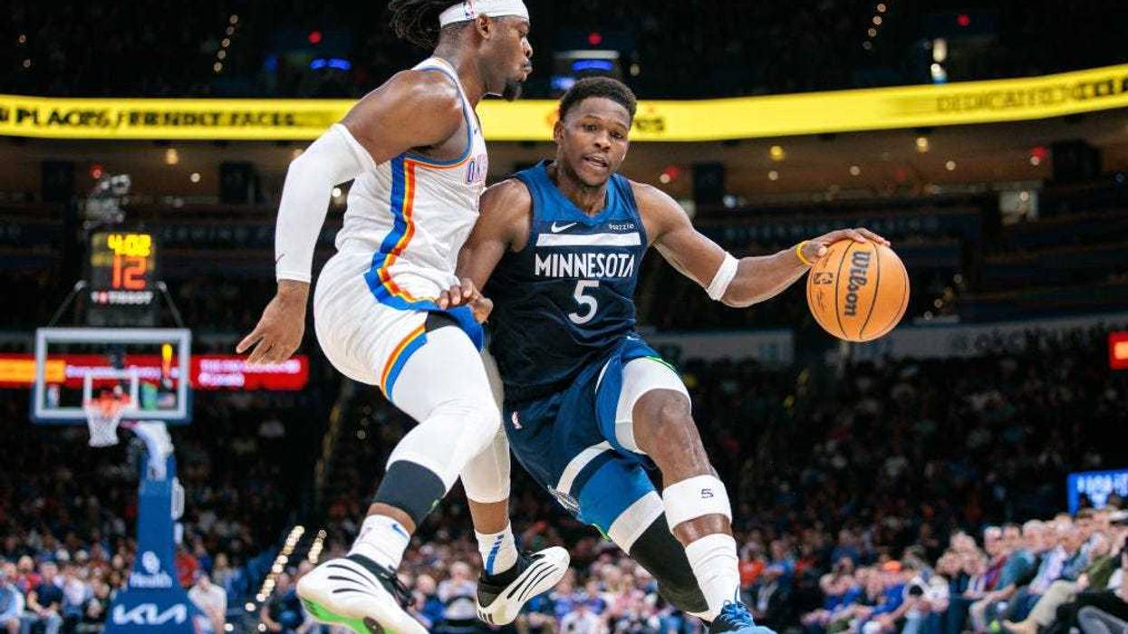 Anthony Edwards #5 of the Minnesota Timberwolves dribbles the ball to the basket around Luguentz Dort #5 of the Oklahoma City Thunder during the fourth quarter at Paycom Center on February 24, 2025 in Oklahoma City, Oklahoma.