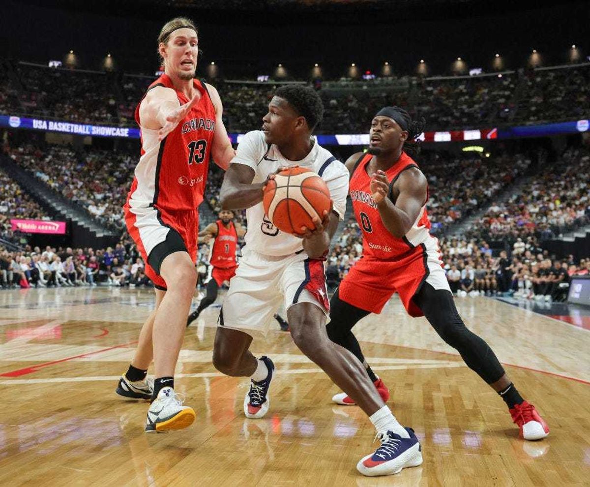 Anthony Edwards #5 of the United States is guarded by Kelly Olynyk #13 and Luguentz Dort #0 of Canada in the second half of their exhibition game ahead of the Paris Olympic Games at T-Mobile Arena on July 10, 2024 in Las Vegas, Nevada. The United States defeated Canada 86-72.