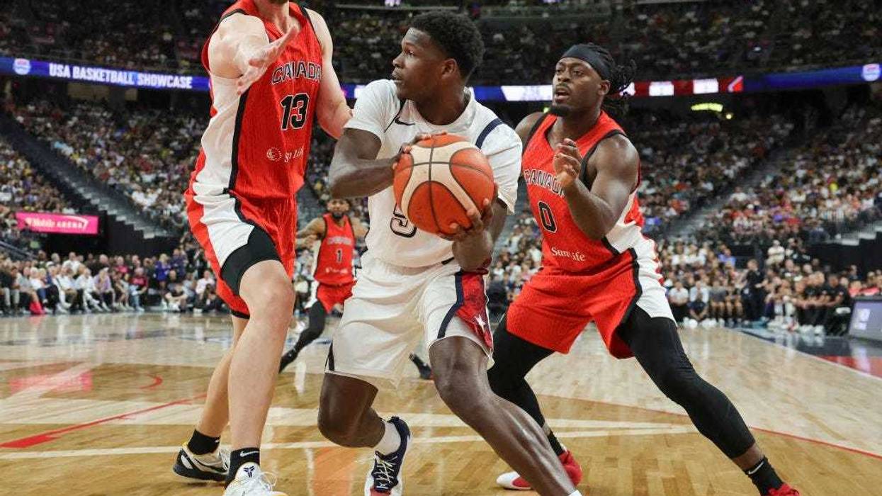 Anthony Edwards #5 of the United States is guarded by Kelly Olynyk #13 and Luguentz Dort #0 of Canada in the second half of their exhibition game ahead of the Paris Olympic Games at T-Mobile Arena on July 10, 2024 in Las Vegas, Nevada. The United States defeated Canada 86-72.