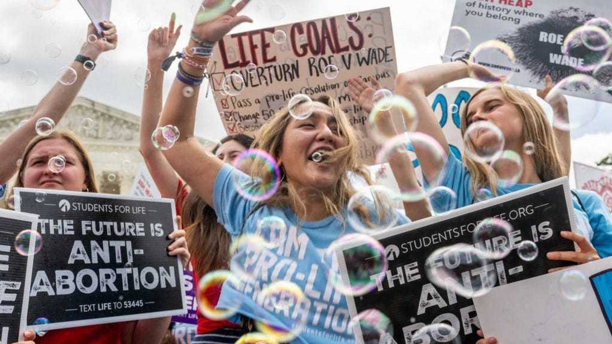 Anti-abortion activists celebrate in response to the Dobbs v Jackson Women's Health Organization ruling in front of the U.S. Supreme Court on June 24, 2022 in Washington, DC.