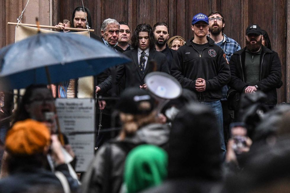 Anti-abortion activists pray while pro-choice activists gather outside of the Basilica of St. Patricks Old Cathedral on May 7, 2022 in New York City.