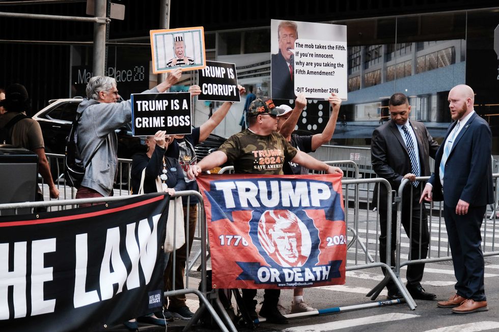 Anti-Trump and pro-Trump demonstrators greet the former president