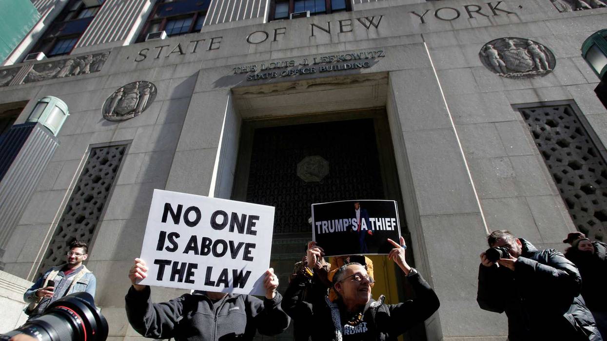 Anti-Trump demonstrators hold signs in Lower Manhattan on March 20, 2023