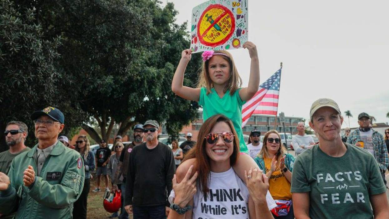 Anti-vaccine protesters stage a protest outside of the San Diego Unified School District office to protest a forced vaccination mandate for students on September 28, 2021, in San Diego, California.