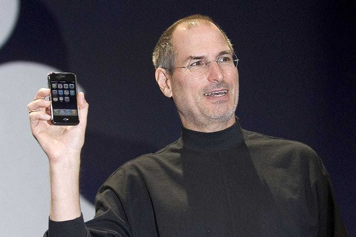 Apple CEO Steve Jobs holds up the new iPhone that was introduced at Macworld on January 9, 2007 in San Francisco, California. During the keynote Jobs introduced the new iPhone which will combine a mobile phone, a widescreen iPod with touch controls and a internet communications device with the ability to use email, web browsing, maps and searching. The iPhone will start shipping in the US in June 2007. (Photo by David Paul Morris/Getty Images)