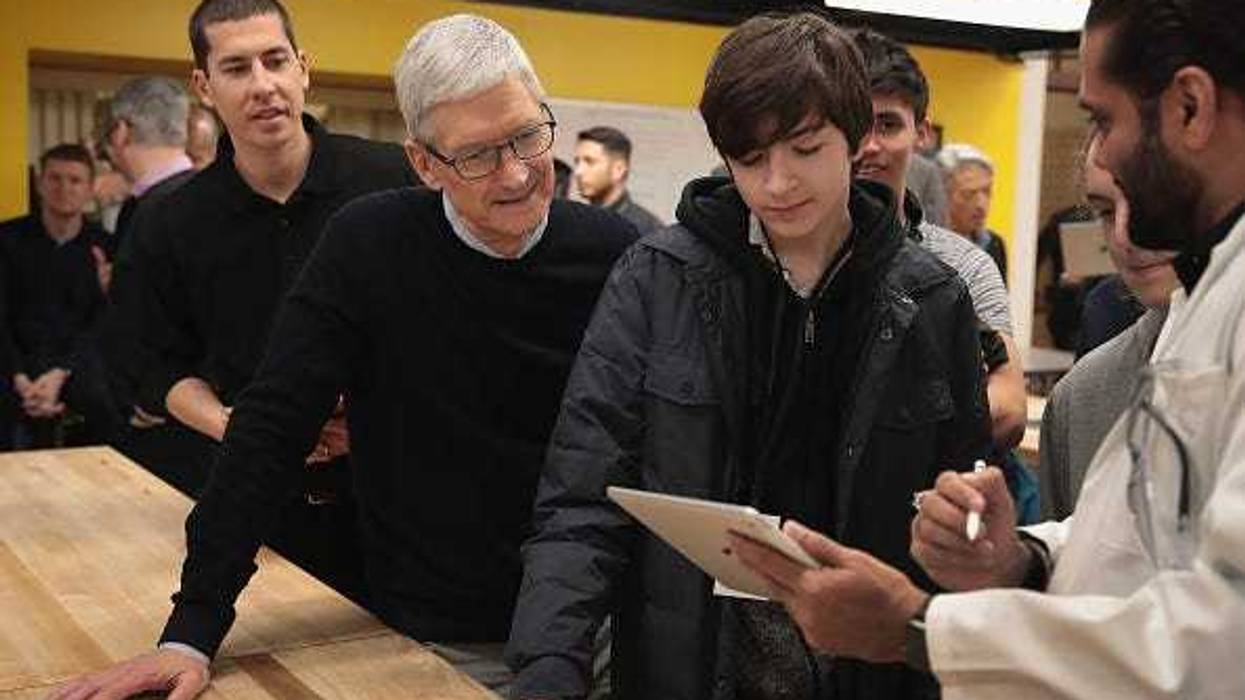 Apple CEO Tim Cook gets a demonstration of an app during an event held to introduce the new 9.7-inch Apple iPad at Lane Tech College Prep High School on March 27, 2018 in Chicago, Illinois. The device will work with Apple Pencil and is available now. (Photo by Scott Olson/Getty Images)