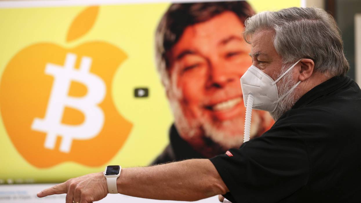 Apple co-founder Steve Wozniak wears a protective mask as he stands next to a photo of himself during a press conference on July 23, 2020 in Burlingame, California.