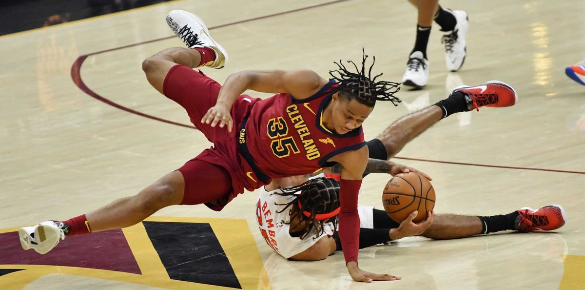 Apr 10, 2021; Cleveland, Ohio, USA; Cleveland Cavaliers forward Isaac Okoro (35) and Toronto Raptors guard DeAndre' Bembry (95) battle for a loose ball during the second quarter at Rocket Mortgage FieldHouse.