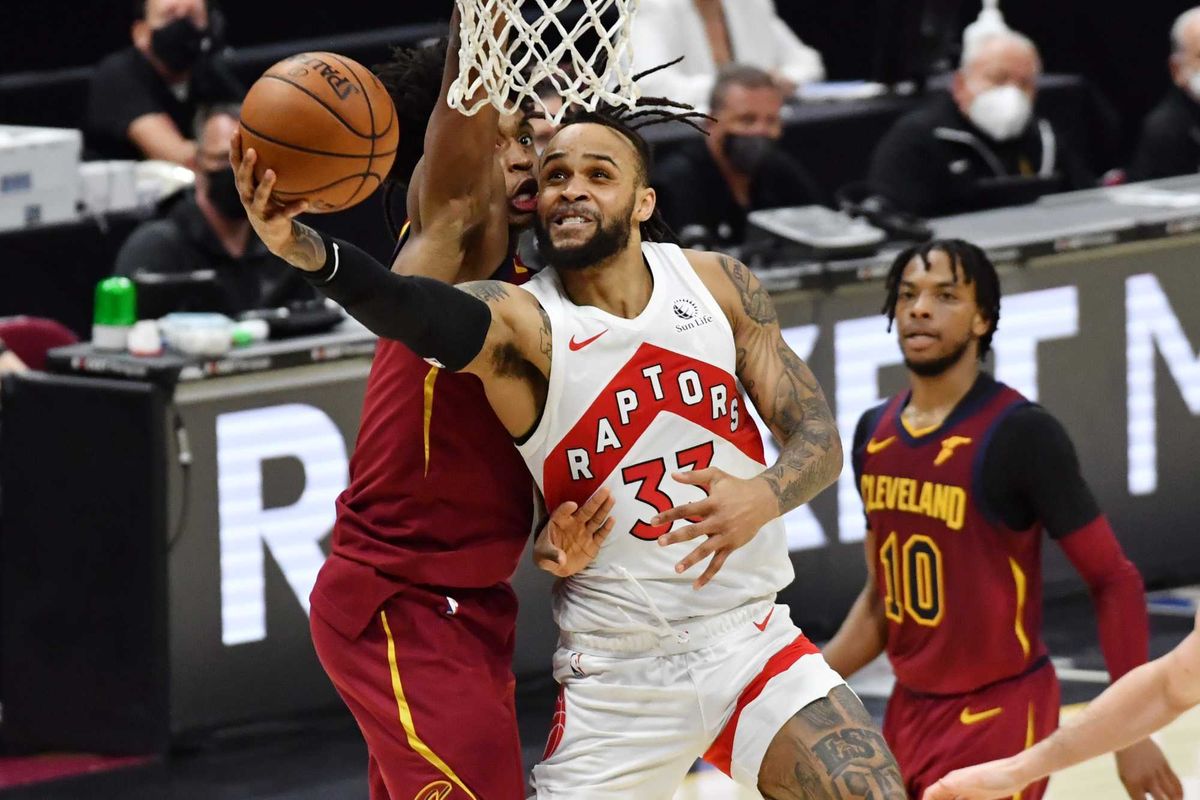 Apr 10, 2021; Cleveland, Ohio, USA; Toronto Raptors guard Gary Trent Jr. (33) drives to the basket against Cleveland Cavaliers guard Collin Sexton (2) during the fourth quarter at Rocket Mortgage FieldHouse.