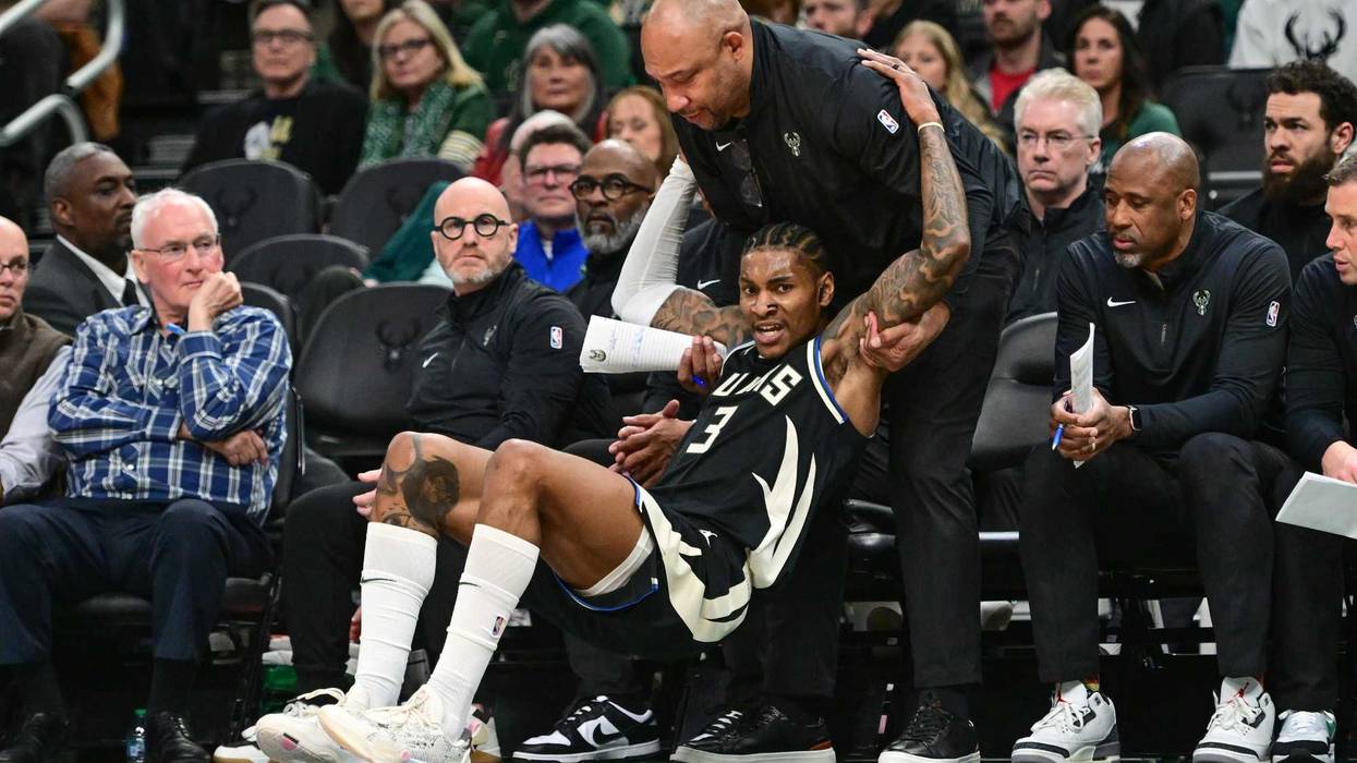 Apr 10, 2025; Milwaukee, Wisconsin, USA; Milwaukee Bucks assistant coach Darlin Ham helps guard Kevin Porter (3) up in the fourth quarter against the New Orleans Pelicans at Fiserv Forum. Mandatory Credit: Benny Sieu-Imagn Images